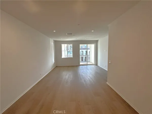 a view of a living room a kitchen with a sink and microwave
