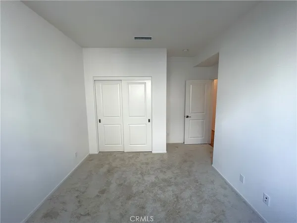 a view of an empty room and closet area
