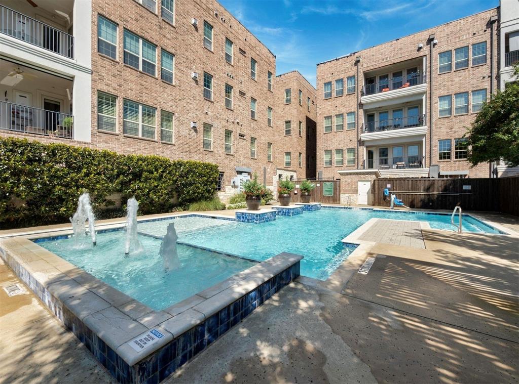 5001 Meridian Lane, Unit 2103 Addison, TX 75001 - Photo 25 of 26 Outdoor swimming pool with integrated fountains, blue mosaic tile accents, surrounding concrete decking, and lush perimeter landscaping