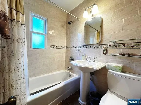 a bathroom with a sink mirror toilet and bathtub