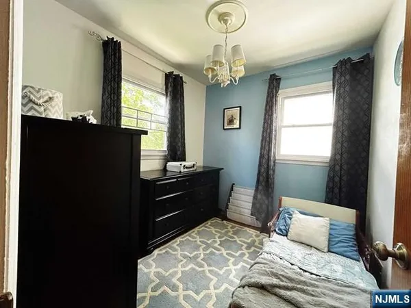 a bedroom with a bed and a chandelier