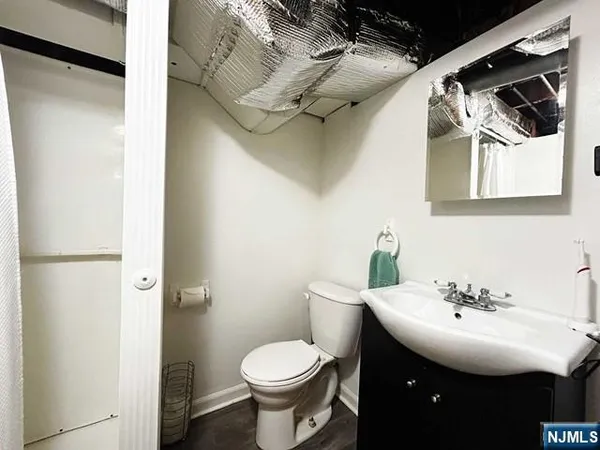 a bathroom with a sink toilet and mirror