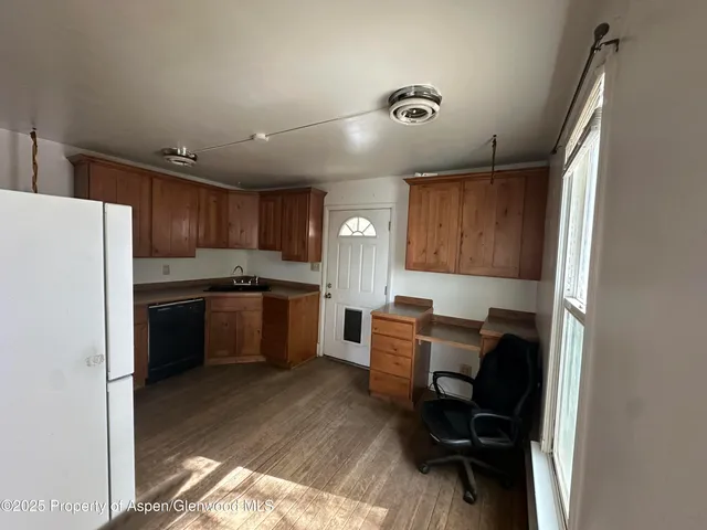 a kitchen with a refrigerator and a sink