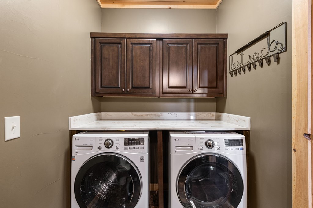 479 Big Timber Road Mineral Bluff, GA 30559 - Photo 17 of 60 a view of washer and dryer with kitchen in the background