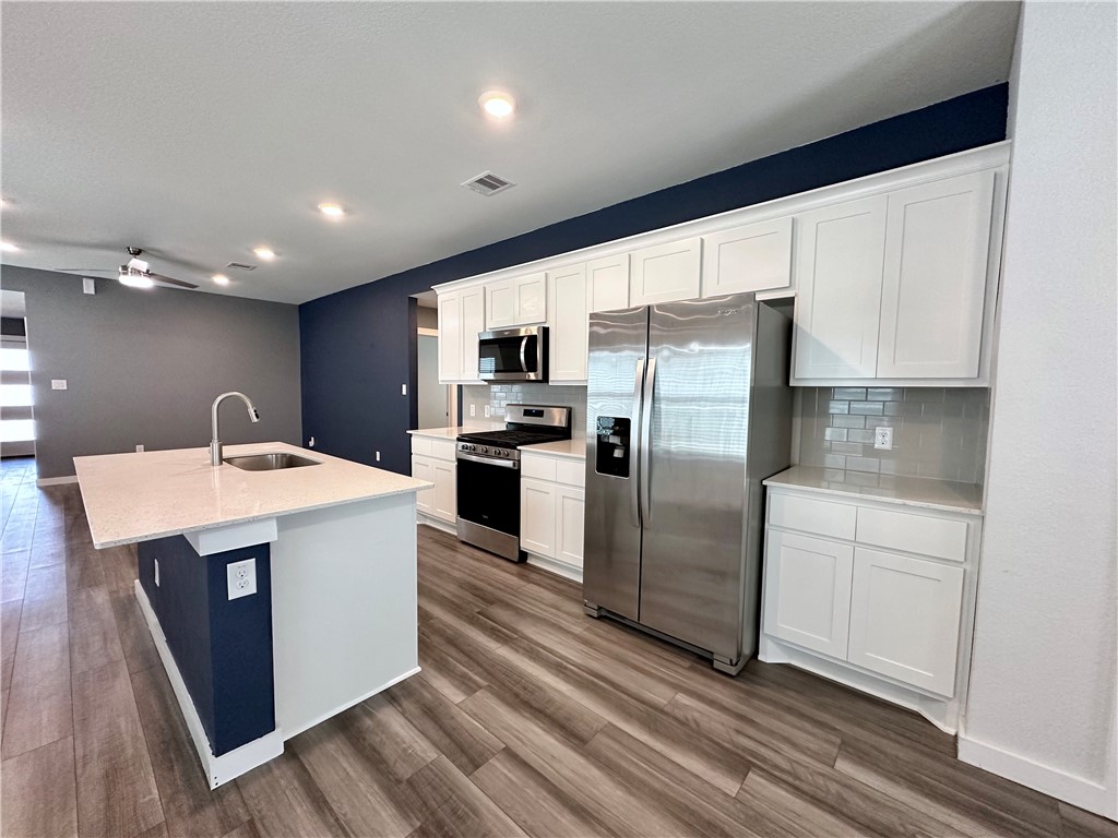 1118 Amistad Loop College Station, TX 77845 - Photo 11 of 26 a kitchen with a sink window and stainless steel appliances