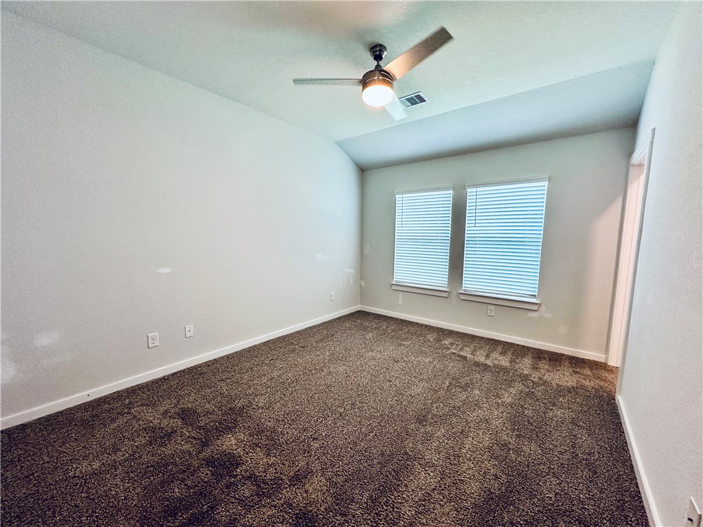 1118 Amistad Loop College Station, TX 77845 - Photo 12 of 26 en empty room with windows and ceiling fan