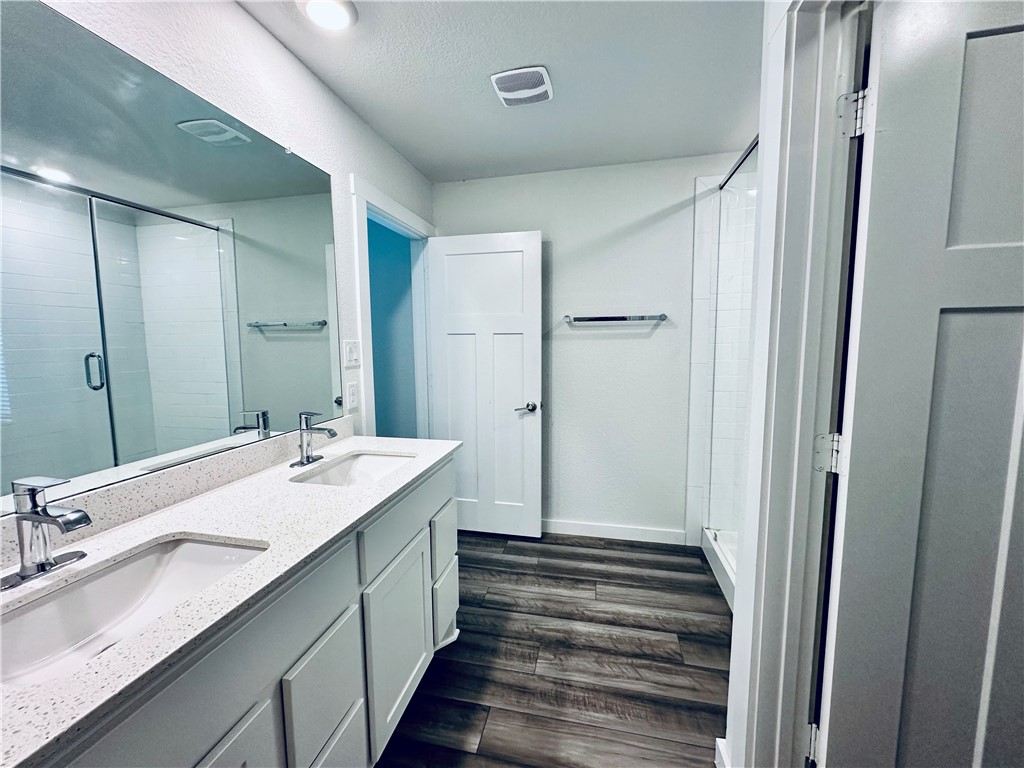 1118 Amistad Loop College Station, TX 77845 - Photo 15 of 26 a bathroom with a double vanity sink and mirror