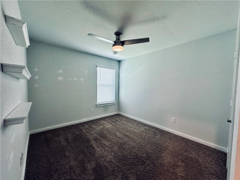 1118 Amistad Loop College Station, TX 77845 - Photo 16 of 26 an empty room with windows and fan
