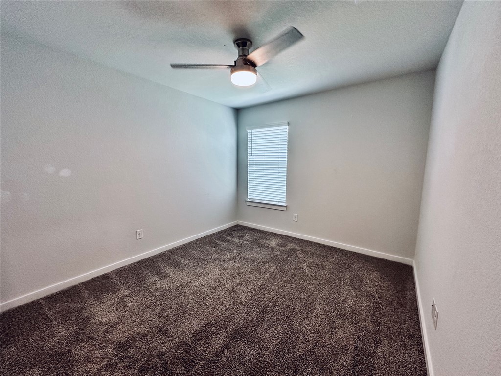 1118 Amistad Loop College Station, TX 77845 - Photo 18 of 26 an empty room with a ceiling fan and window