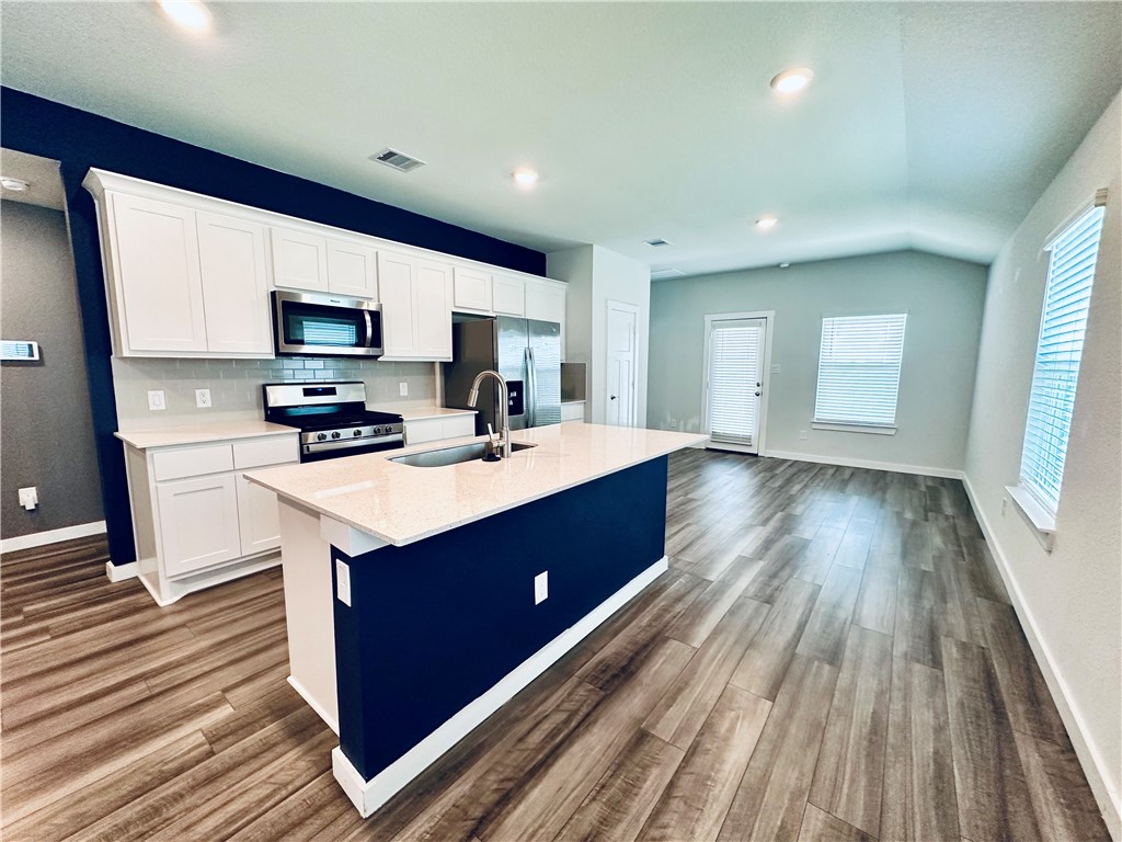 1118 Amistad Loop College Station, TX 77845 - Photo 5 of 26 a kitchen with stainless steel appliances granite countertop a sink stove and cabinets