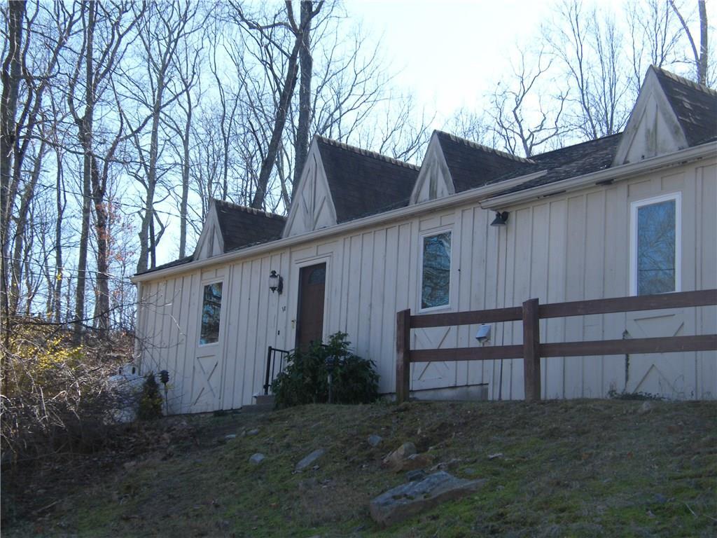 a view of backyard of house with wooden fence