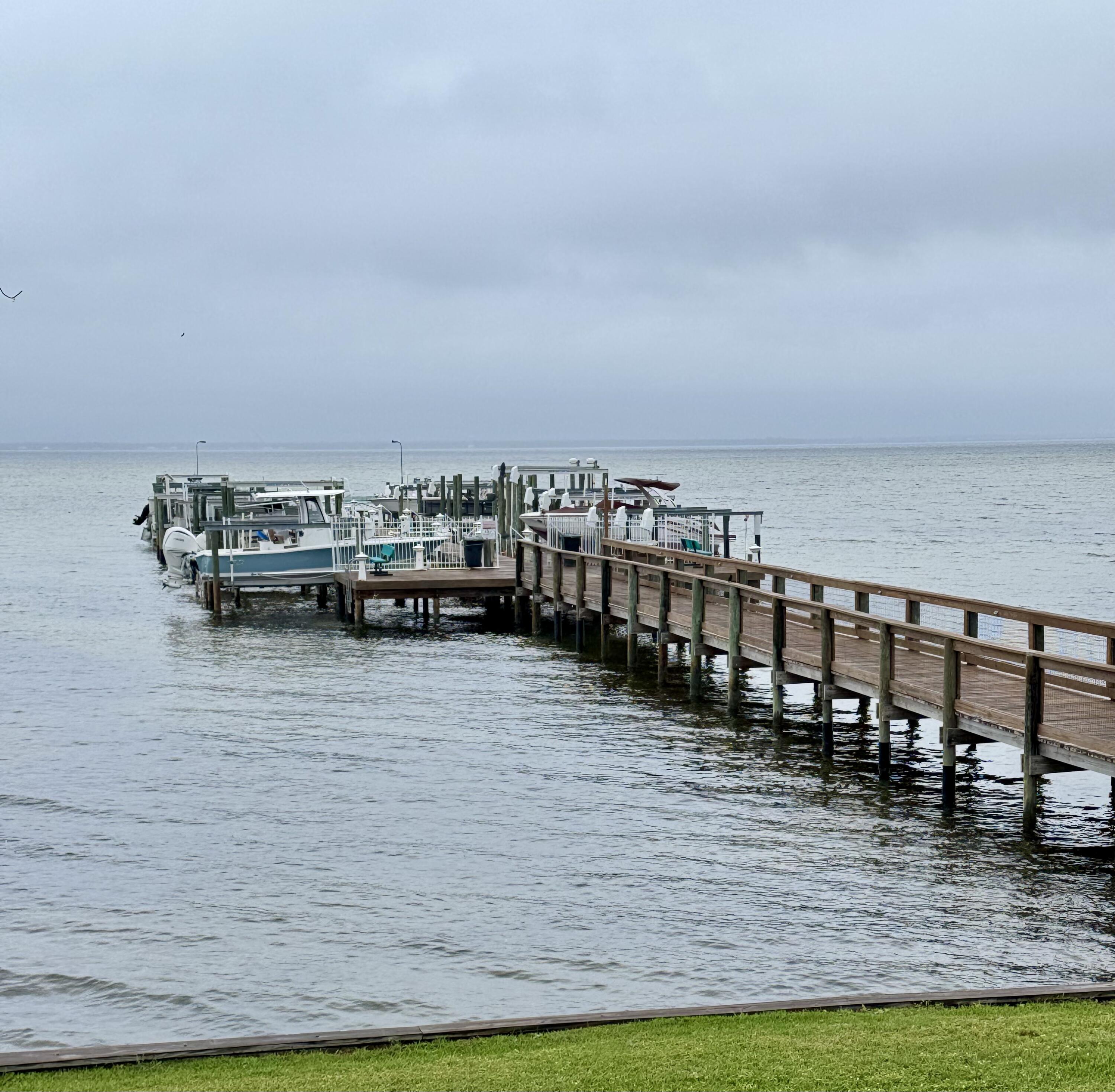 3857 Indian Trail, Unit 507 Destin, FL 32541 - Photo 27 of 33 a view of ocean with boats and trees in the background