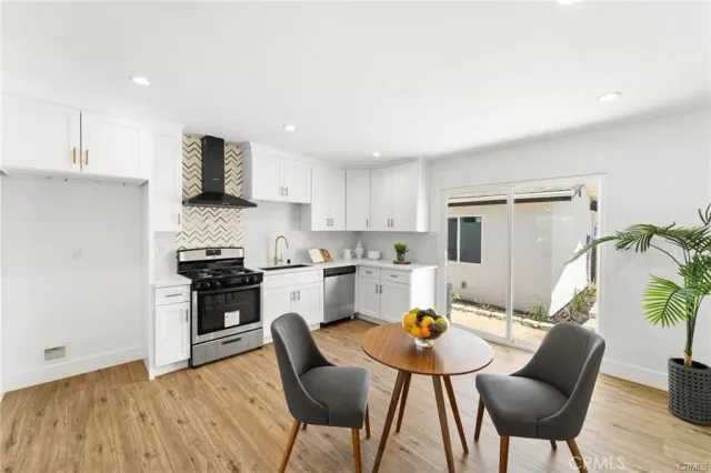 a kitchen with stainless steel appliances kitchen island granite countertop a sink and a refrigerator