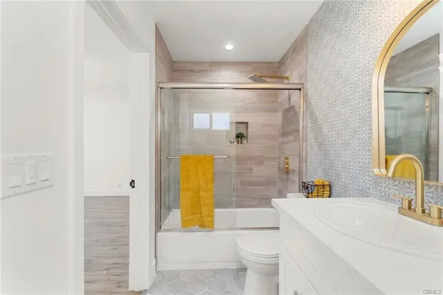 a bathroom with a sink mirror toilet and bathtub