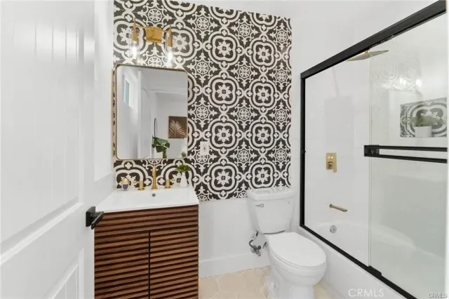 a bathroom with a toilet sink and shower curtain