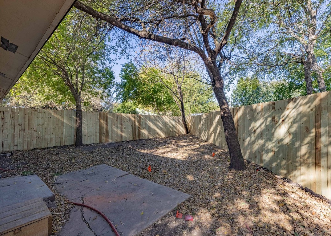 4600 Rocking Chair Road, Unit B Austin, TX 78744 - Photo 7 of 7 a view of a backyard with large trees