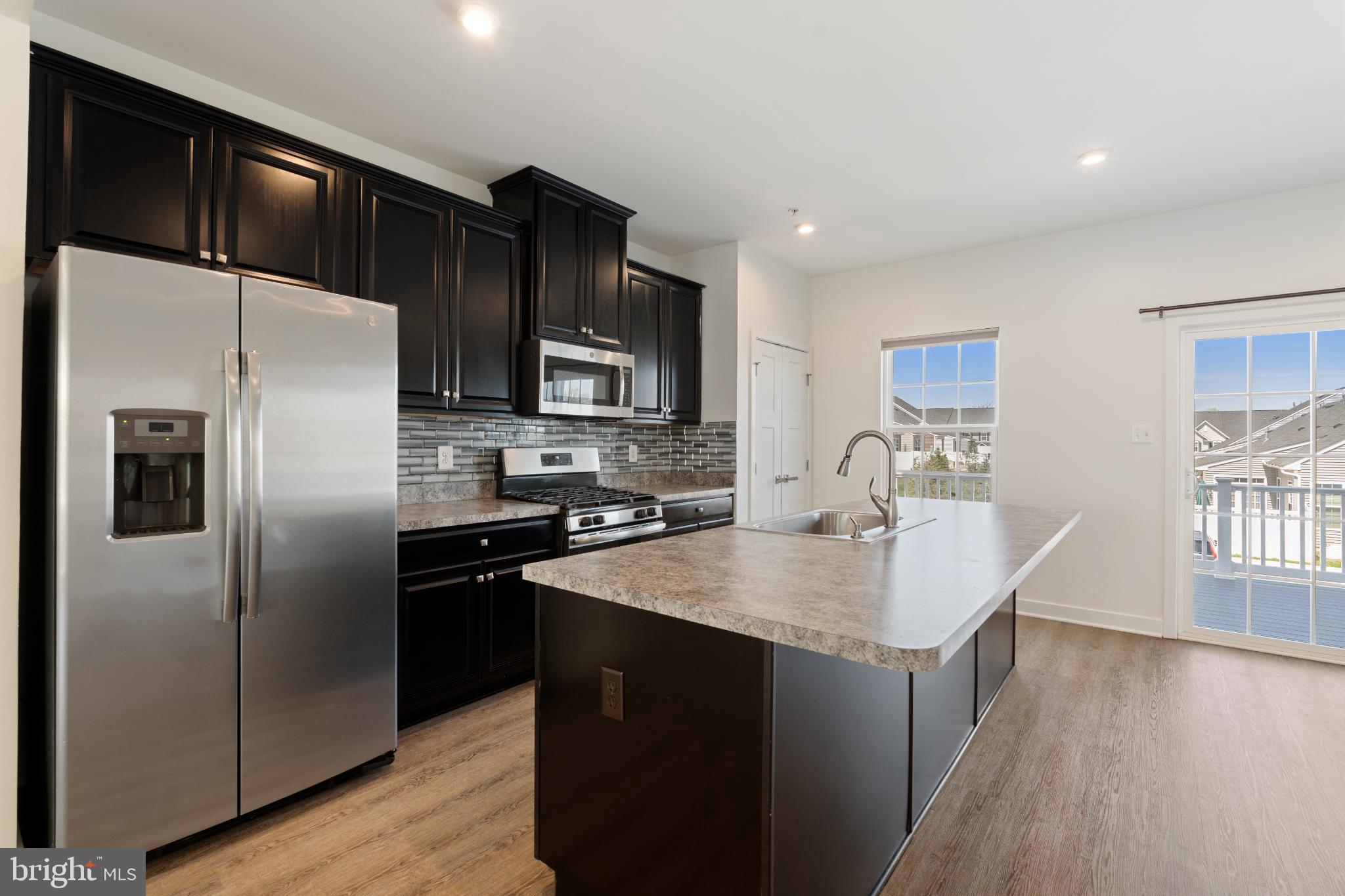 6510 Ballenger Run Boulevard Frederick, MD 21703 - Photo 4 of 18 a kitchen with kitchen island a counter top space cabinets and appliances