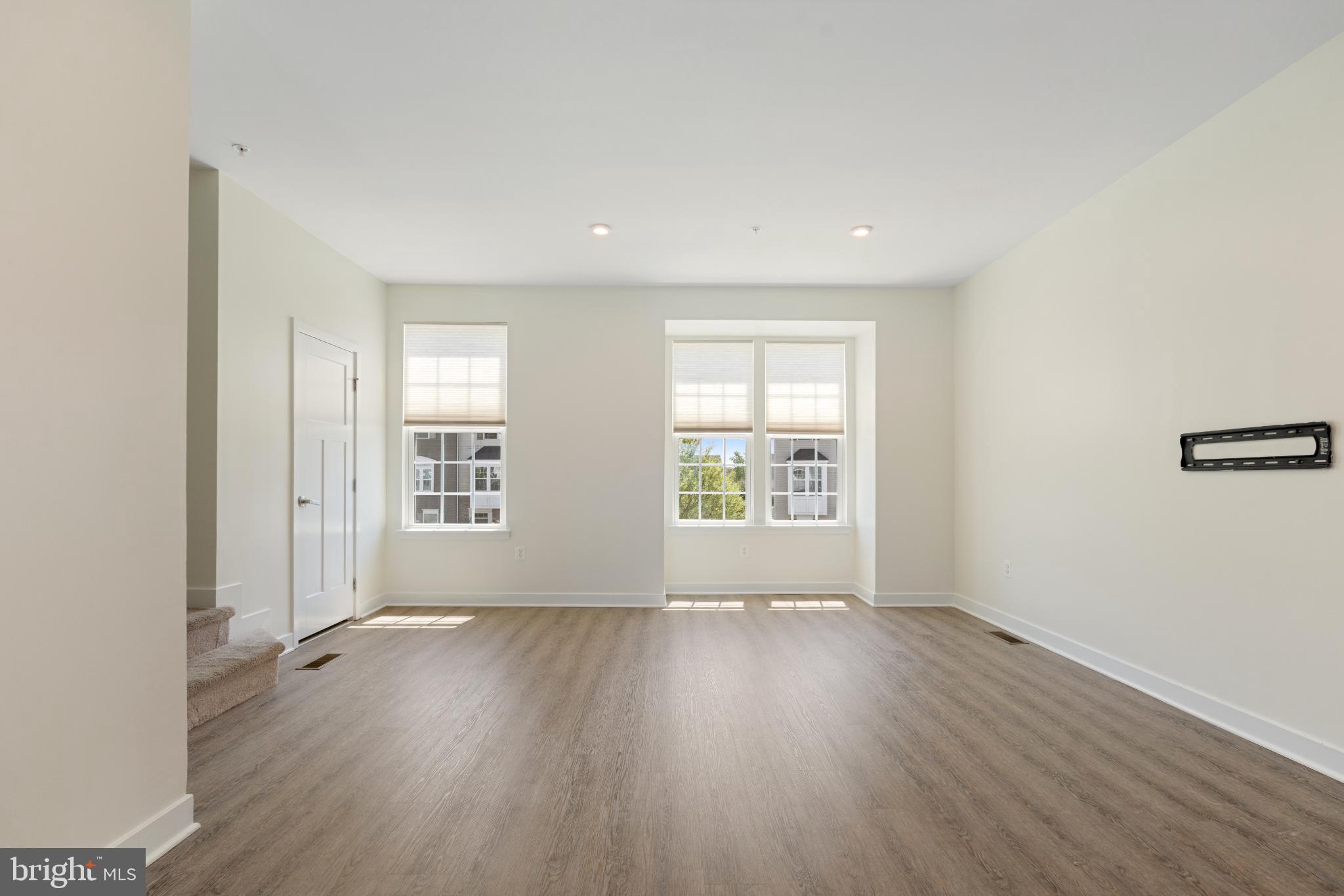 6510 Ballenger Run Boulevard Frederick, MD 21703 - Photo 6 of 18 an empty room with wooden floor and windows