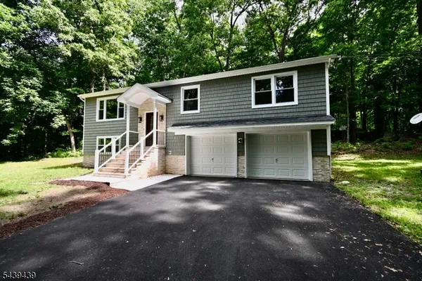 a kitchen with stainless steel appliances granite countertop a refrigerator sink and stove