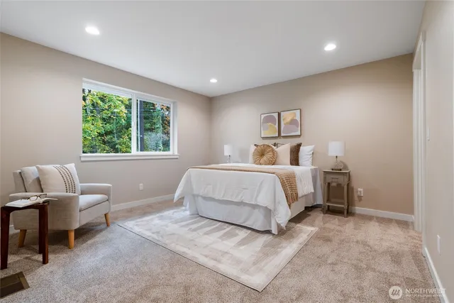 a bedroom with a large bed and a chair