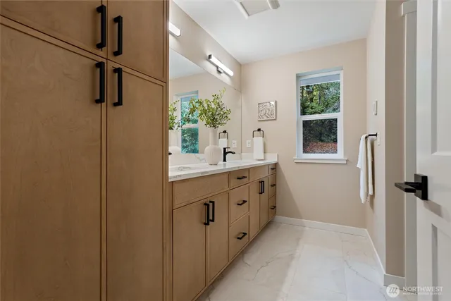 a bathroom with a double vanity sink a and a window