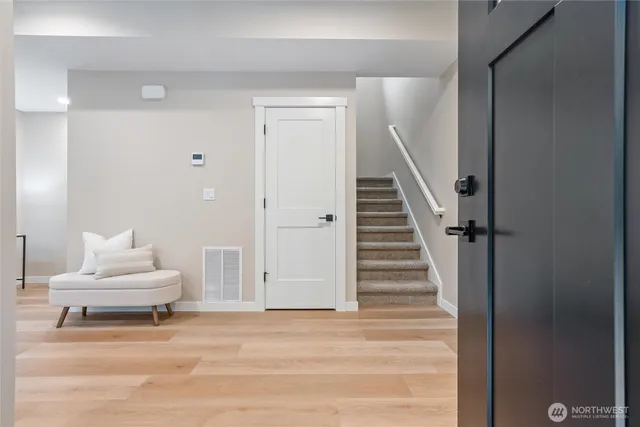 a view of entryway and hall with wooden floor