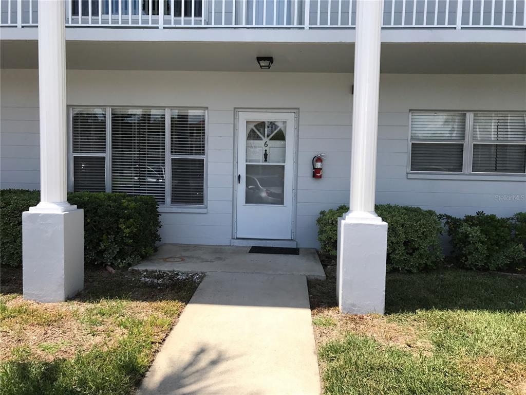2450 Canadian Way, Unit 6 Clearwater, FL 33763 - Photo 1 of 1 a front view of a house with garden