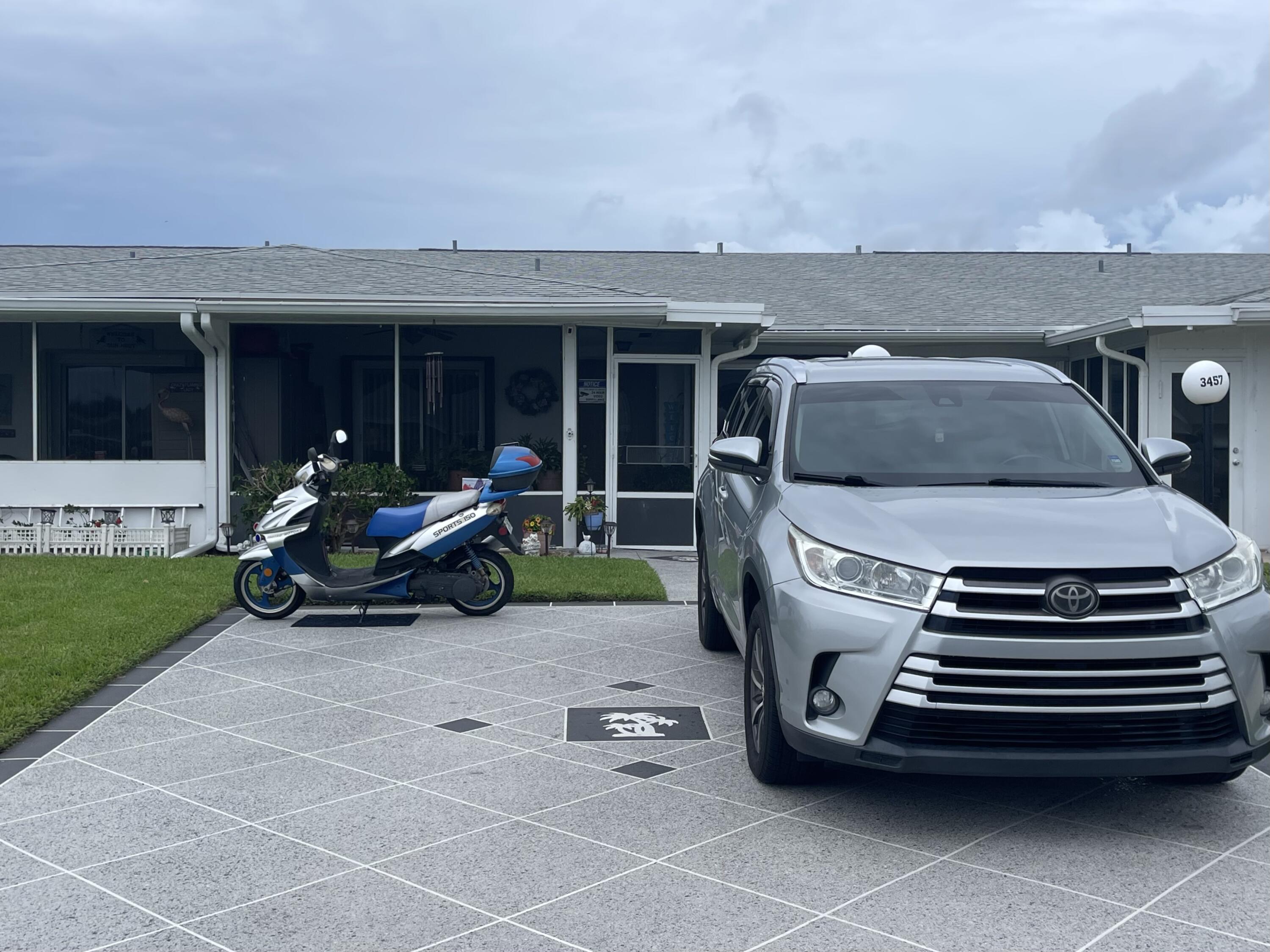 a view of a patio with table and chairs with wooden fence
