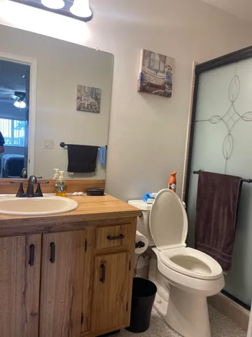 a view of a bathroom with a toilet sink and mirror