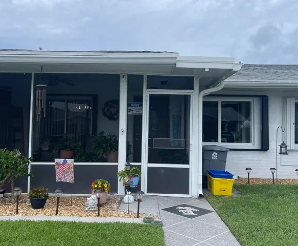 a view of a house with a backyard porch and sitting area