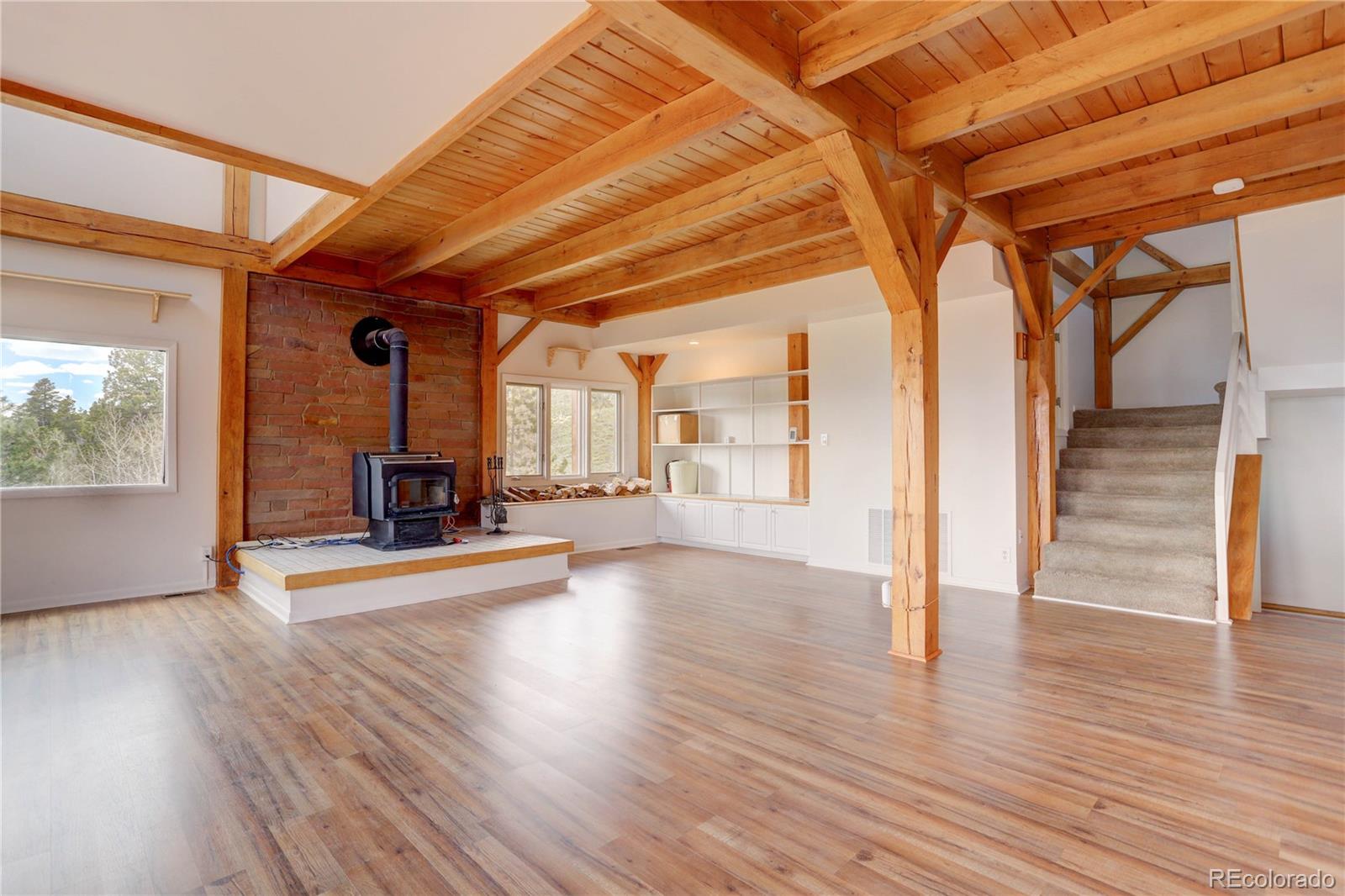 400 Alpine Way Idaho Springs, CO 80452 - Photo 12 of 40 a view of a hall with wooden floor and a fireplace