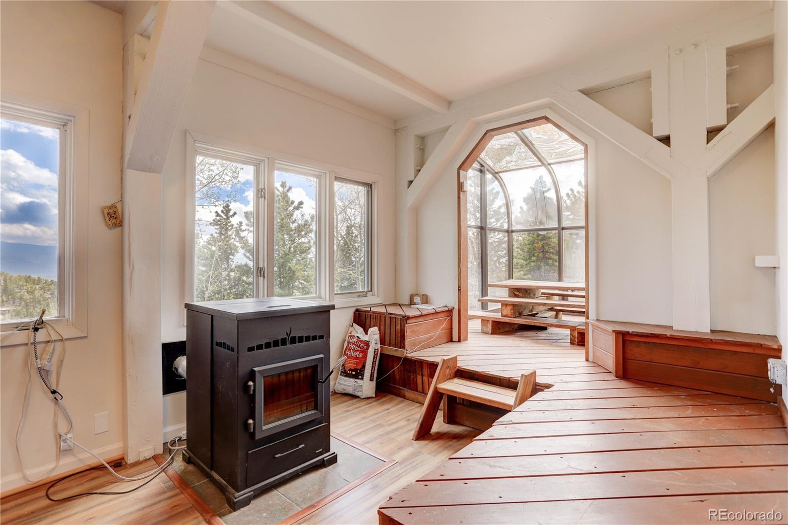 400 Alpine Way Idaho Springs, CO 80452 - Photo 30 of 40 a living room with furniture and a fireplace