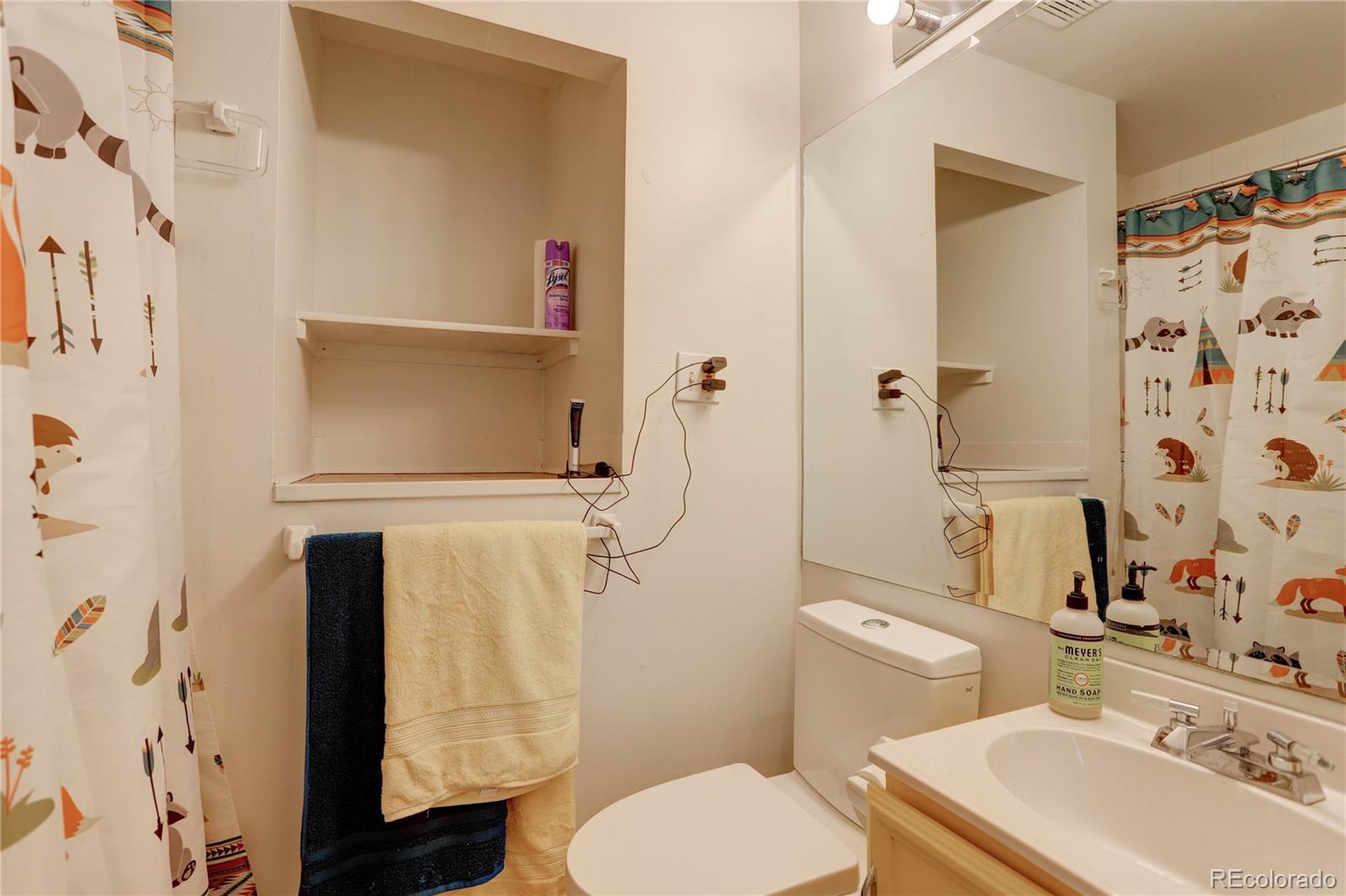 400 Alpine Way Idaho Springs, CO 80452 - Photo 35 of 40 a white toilet sitting next to a bathroom sink