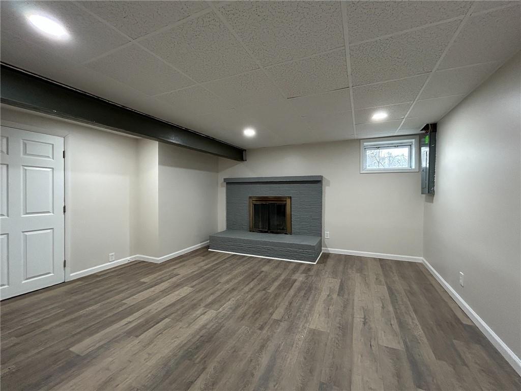 389 Rural Valley Road Claysville, PA 15323 - Photo 28 of 35 an empty room with wooden floor and fireplace