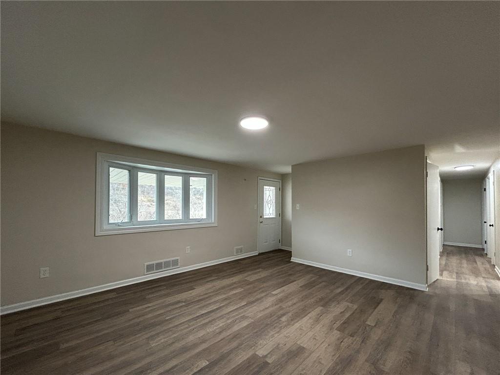 389 Rural Valley Road Claysville, PA 15323 - Photo 8 of 14 an empty room with wooden floor and windows