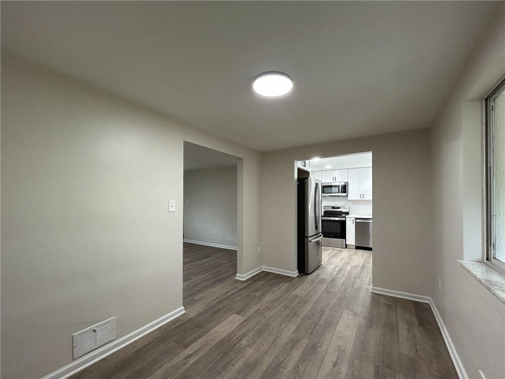 389 Rural Valley Road Claysville, PA 15323 - Photo 9 of 14 wooden floor in an empty room with a window