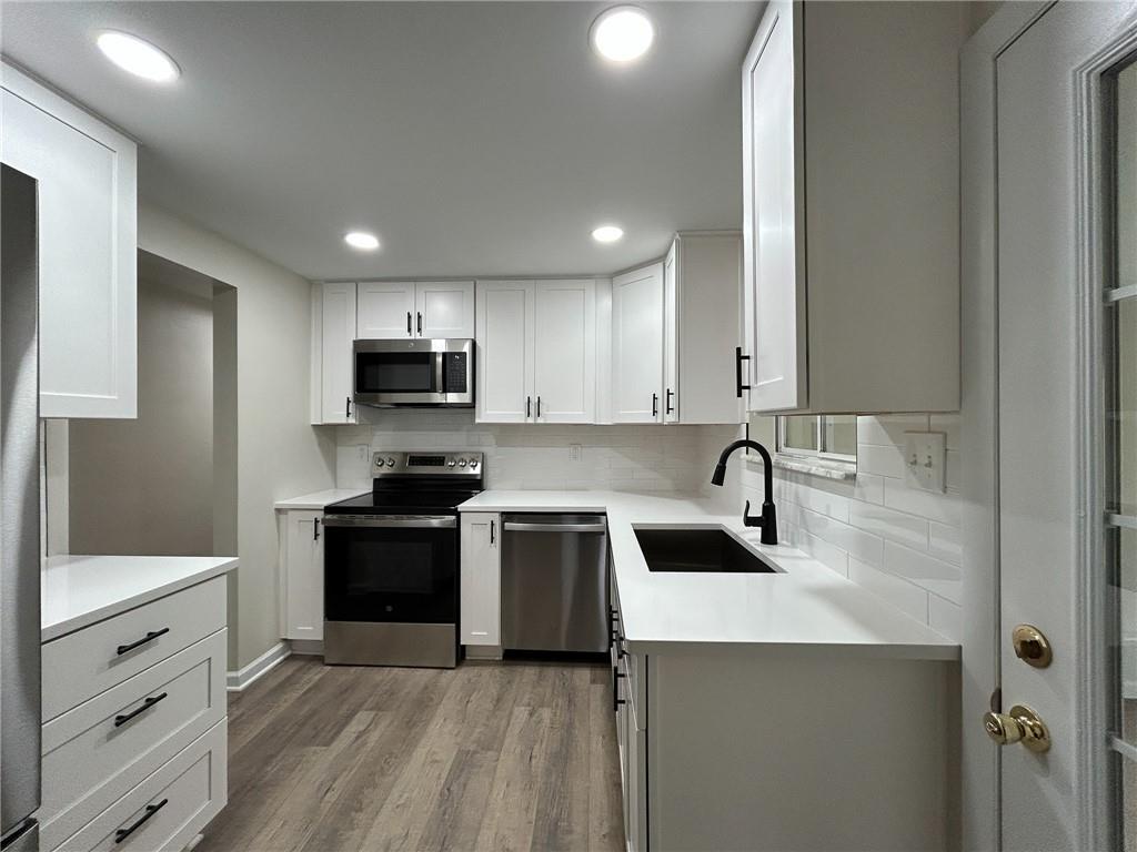 389 Rural Valley Road Claysville, PA 15323 - Photo 10 of 14 a kitchen with granite countertop a sink stove and refrigerator