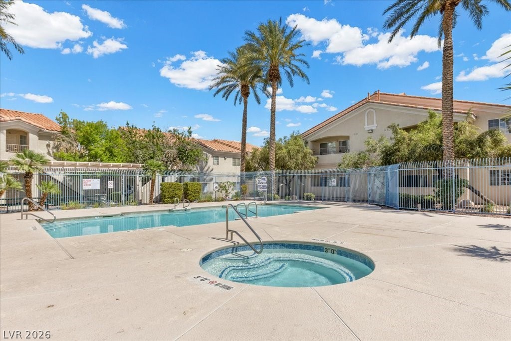 1881 West Alexander Road, Unit 1037 North Las Vegas, NV 89032 - Photo 25 of 31 A refreshing resort style community pool and spa area with palm trees