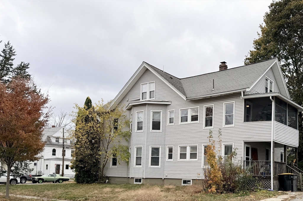 20 Clark Street, Unit 1 Framingham, MA 01702 - Photo 1 of 17 a view of a white building among the street with palm trees