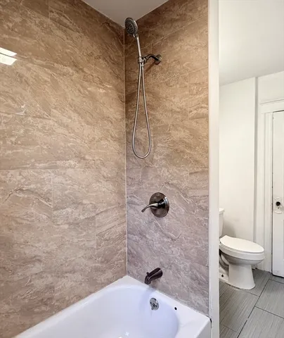 a bathroom with a bathtub and a toilet