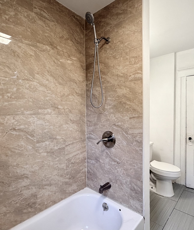 20 Clark Street, Unit 1 Framingham, MA 01702 - Photo 3 of 17 a bathroom with a bathtub and a toilet