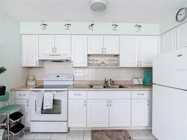 a kitchen with cabinets appliances and a sink