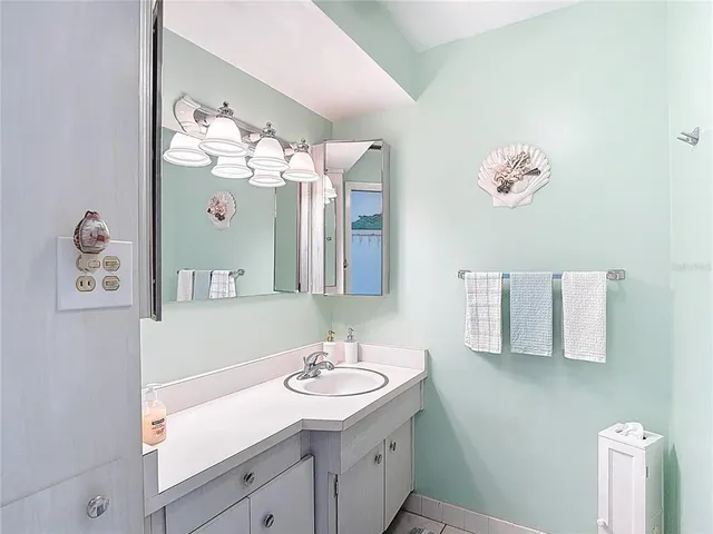 a bathroom with a granite countertop sink mirror and toilet