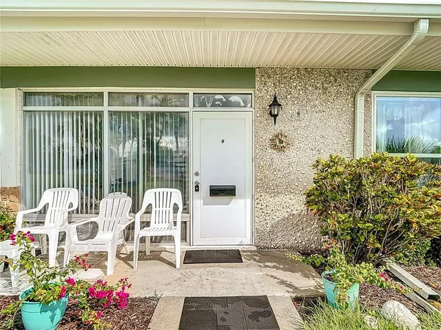 a balcony with table and chairs