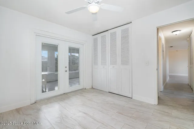wooden floor in an empty room with a bathroom