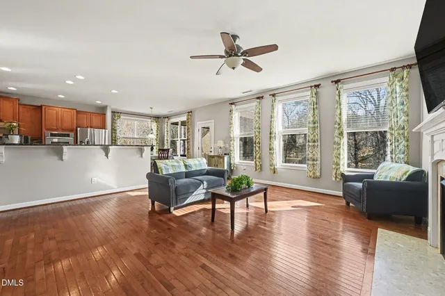 a living room with furniture fireplace and flat screen tv