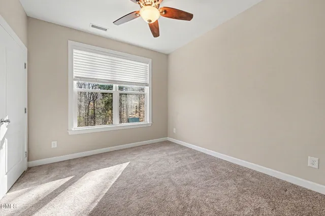 a living room with furniture cabinets and a window