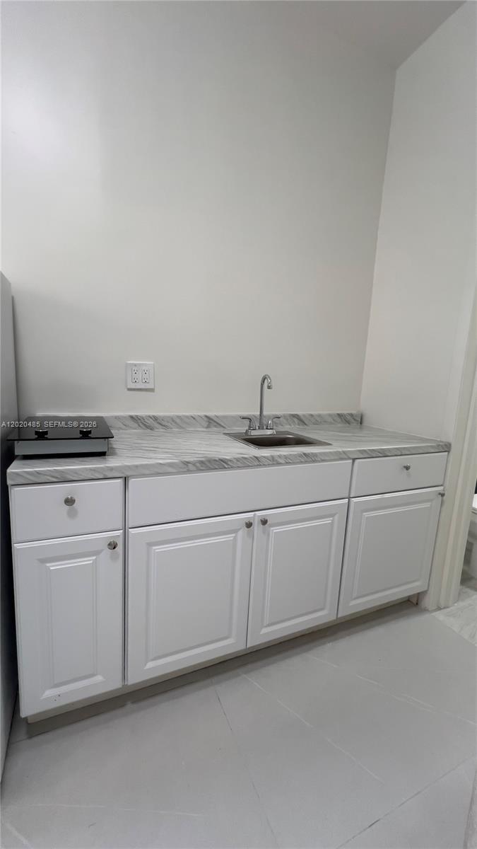 1845 Bay Road, Unit 1 Miami Beach, FL 33139 - Photo 2 of 9 a kitchen with white cabinets