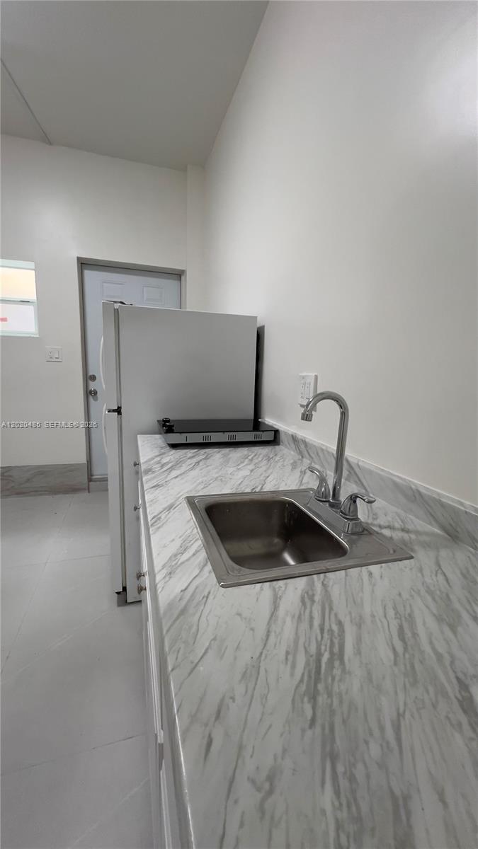 1845 Bay Road, Unit 1 Miami Beach, FL 33139 - Photo 3 of 9 a view of a kitchen with a sink and dishwasher