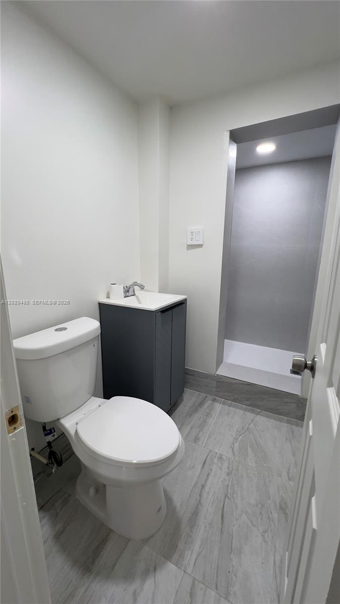 1845 Bay Road, Unit 1 Miami Beach, FL 33139 - Photo 7 of 9 a white toilet sitting next to a bathroom sink